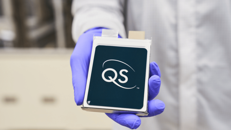 Volkswagen Group’s PowerCo and QuantumScape partner to industrialize solid-state batteries A scientist in a white coat and purple gloves holds a 24-layer prototype battery cell in QuantumScape’s format