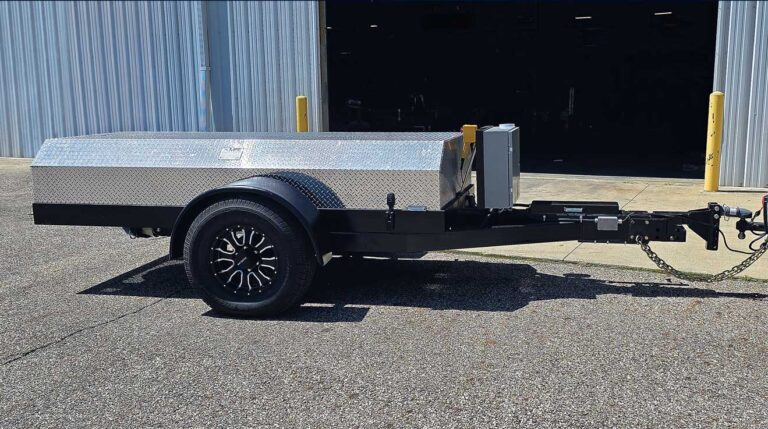 The Kubota ultra lightweight tow dynamometer shown on the tarmac outside a garage, in the sunshine.
