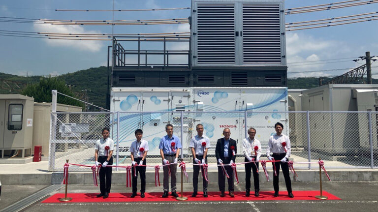 Honda begins joint demonstration of stationary FC power station using by-product hydrogen and repurposed fuel cells Opening ceremony of the fuel cell power station with seven representatives of Honda Motor Co, Tokuyama Corporation and Mitsubishi Corporation standing on a red carpet out the front of building