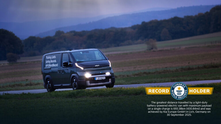 Kia PV5 Cargo on a road with Guinness World Record logo in the right hand corner of the image