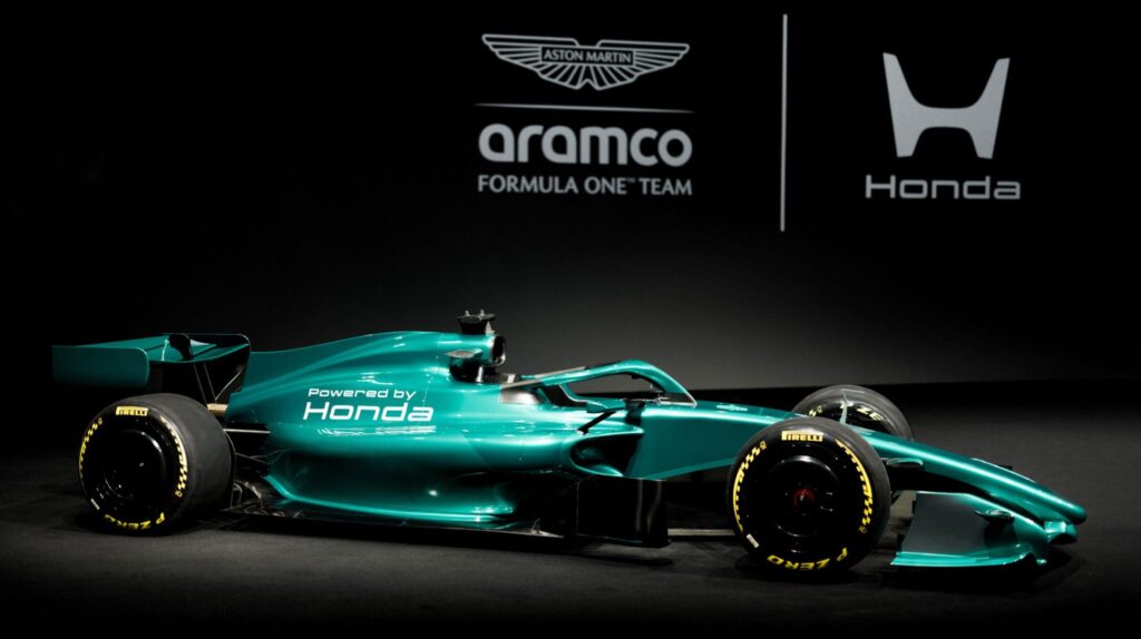 The Aramco Formula One Team vehicle on a stage in a promotional pic, with the team brand and logo in green behind.