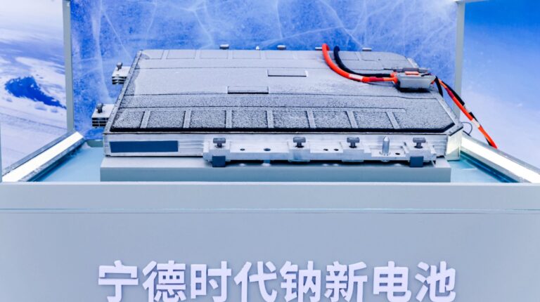 Close up of CATL's first mass-production sodium-ion battery. It is grey with red and black wires on one end.