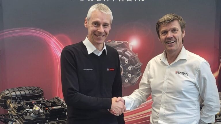 Alan Bell, senior manager at Bosch Motorsport UK, and Peter Harris, electricals and controls manager at Swindon Powertrain, shake hands.