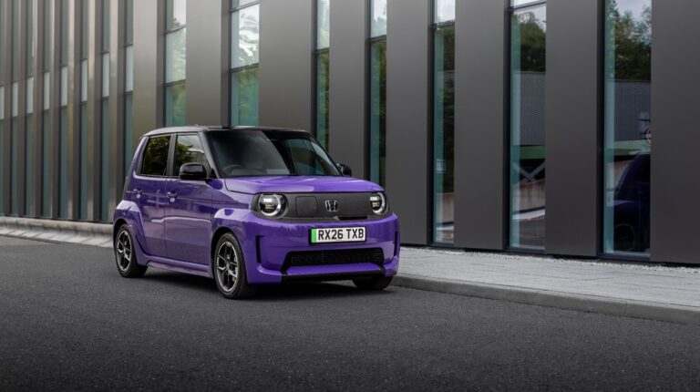Honda Super-N compact EV delivers 70kW in boost mode and 199-mile “city range” A purple Honda Super-N drives through an emoty urban street with a glass building in the background.