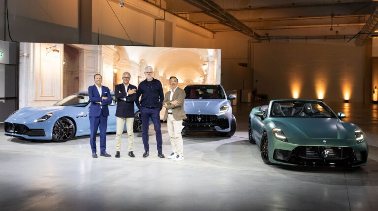 Maserati representatives stand in front of the new Grecale, GranTurismo and GranCabrio in a light brown-panelled showroom.