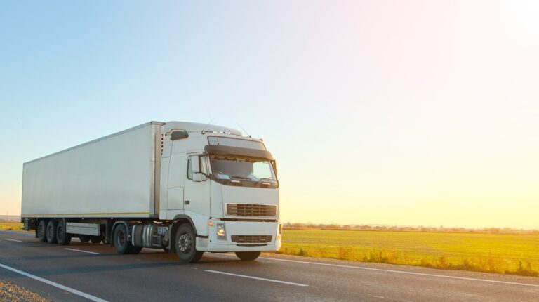 Engine Technology Forum testifies to EPA on heavy-duty engines and SCR control systems A white truck drives along an empty rural highway as the sun sets.