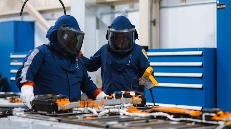 Q&A: Tony Mancina, Stellantis Canada Two laboratory workers wearing blue protection suits and visors inspect a piece of equipment.